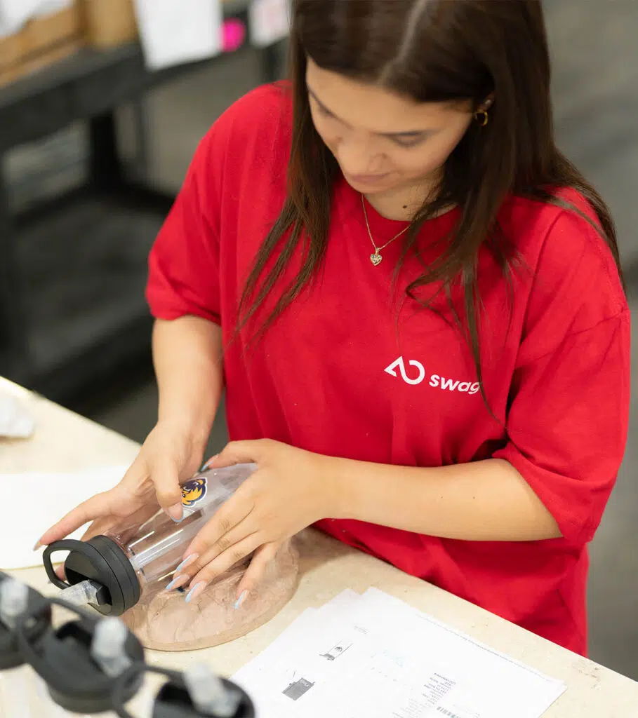 AO Swag employee preparing promotional products through on-demand production